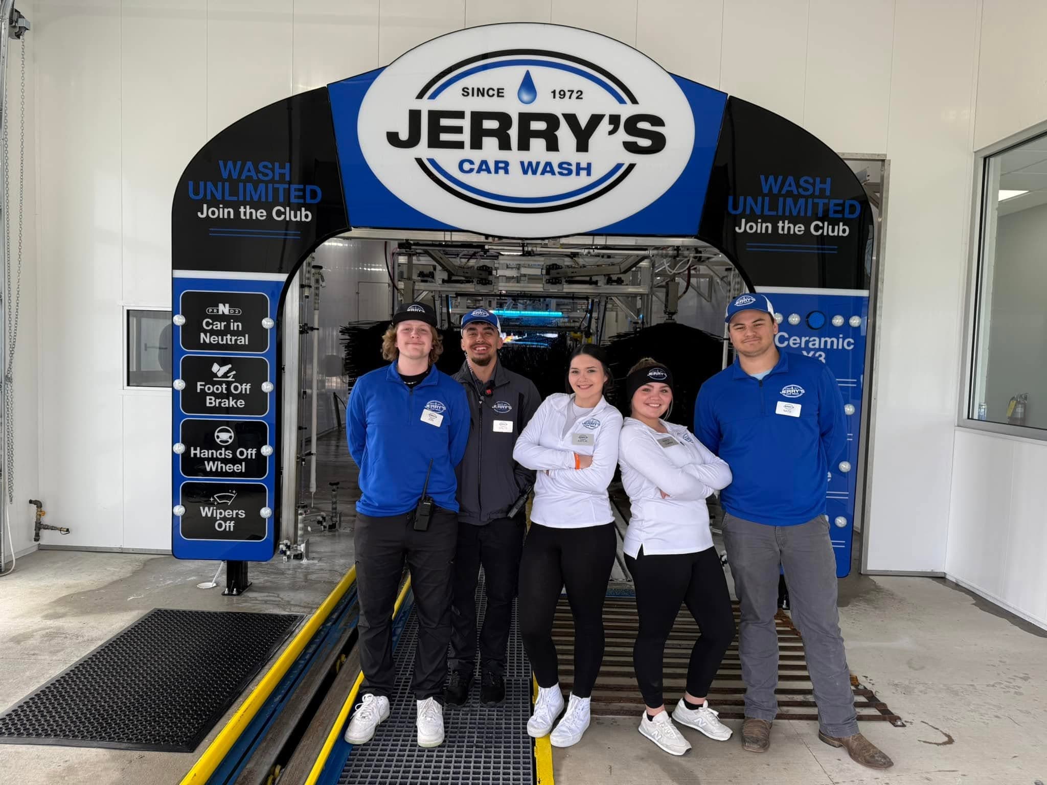 The Jerry's Car Wash family and team under the Jerry's Car Wash arch